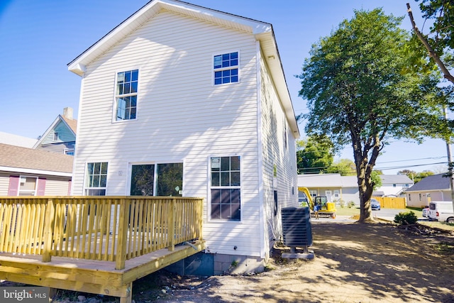 back of property with a wooden deck and central AC unit