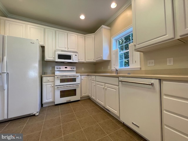 kitchen featuring white appliances, ornamental molding, and white cabinets