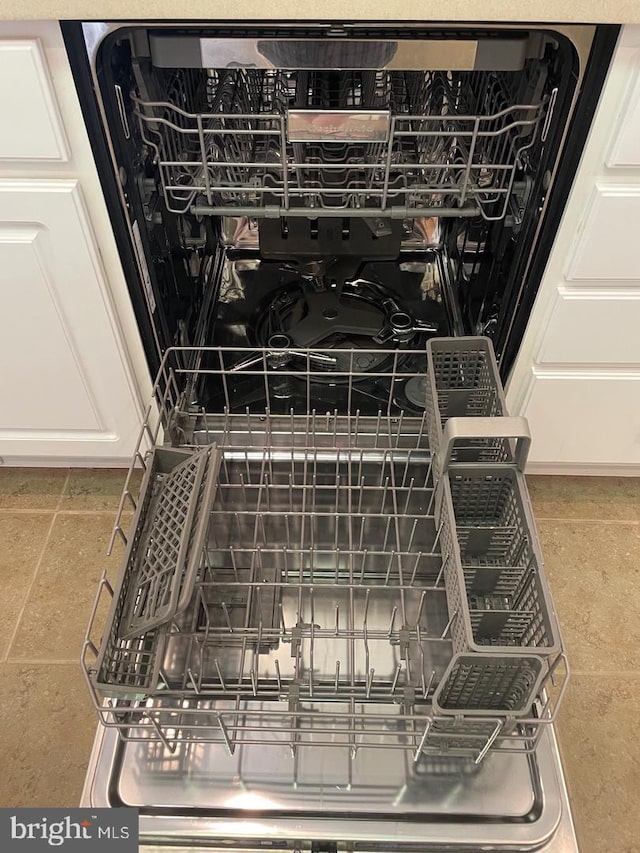 interior details with dishwasher and white cabinets