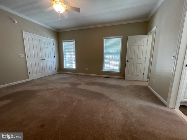 unfurnished bedroom with ceiling fan, carpet, and ornamental molding