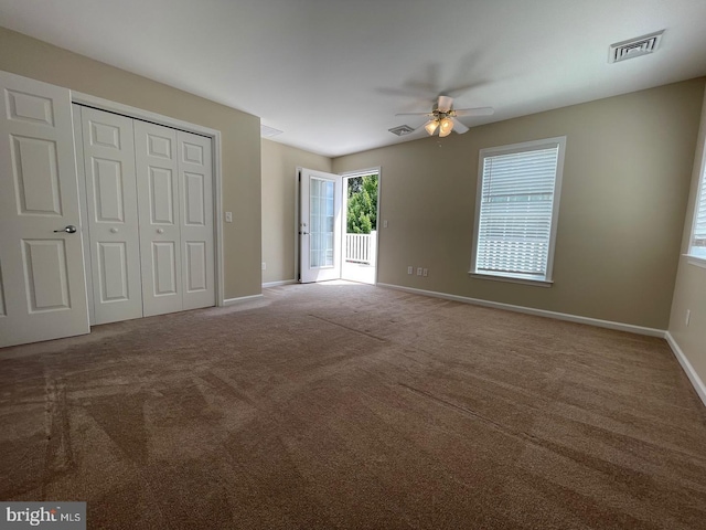 unfurnished bedroom featuring carpet, access to outside, and ceiling fan