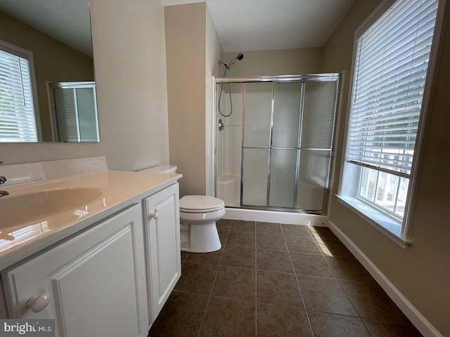 bathroom featuring toilet, an enclosed shower, vanity, and tile patterned floors