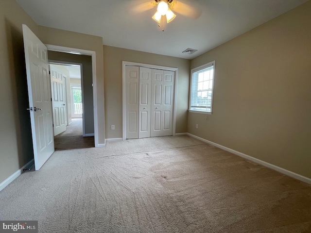 unfurnished bedroom featuring carpet flooring, a closet, and ceiling fan