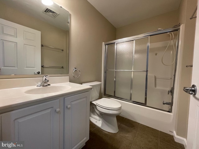 full bathroom with toilet, bath / shower combo with glass door, vanity, and tile patterned floors