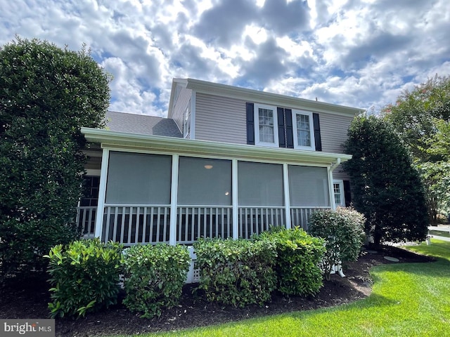 view of home's exterior with a sunroom