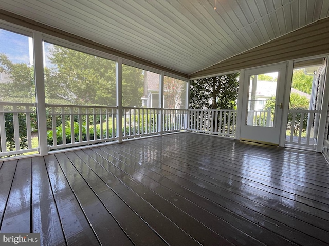 unfurnished sunroom featuring vaulted ceiling, wooden ceiling, and a wealth of natural light