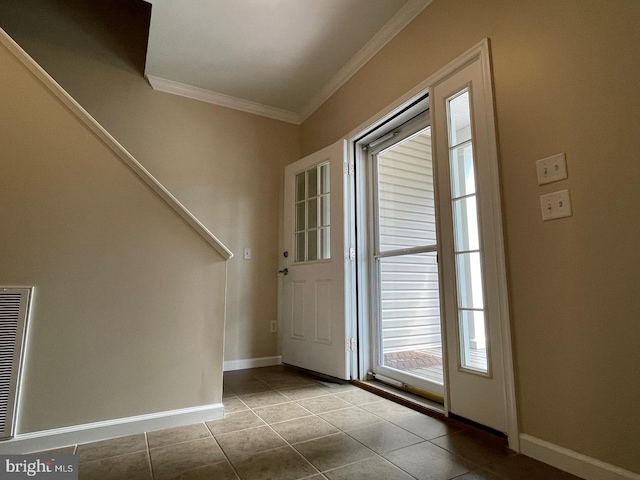 doorway with crown molding and light tile patterned floors