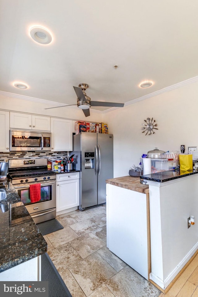 kitchen featuring white cabinets, stainless steel appliances, ceiling fan, and crown molding