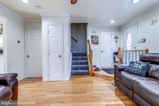 living room featuring ornamental molding and light wood-type flooring