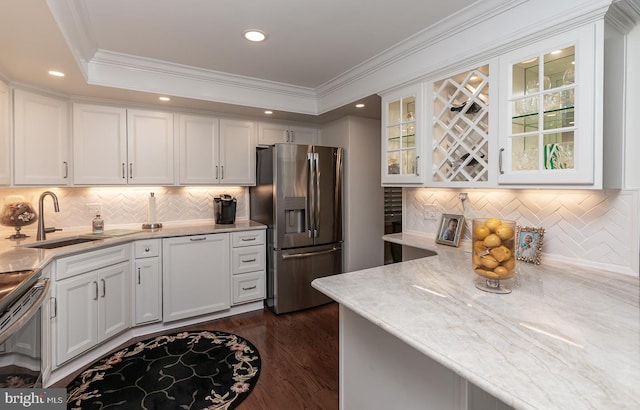 kitchen with white cabinets, ornamental molding, sink, and stainless steel fridge with ice dispenser