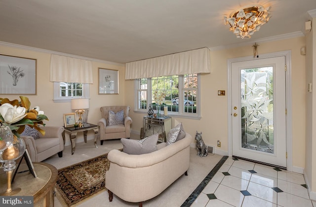 living room featuring light tile patterned flooring, a notable chandelier, a healthy amount of sunlight, and crown molding