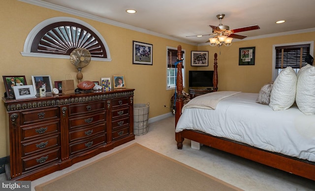 carpeted bedroom featuring ornamental molding and ceiling fan