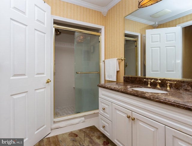 bathroom featuring ornamental molding, an enclosed shower, vanity, and tile patterned floors