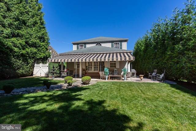 back of property featuring a patio area and a yard