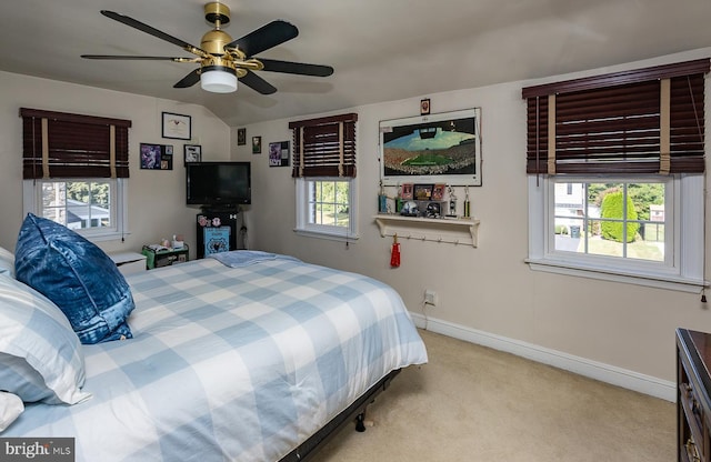 carpeted bedroom with multiple windows and ceiling fan