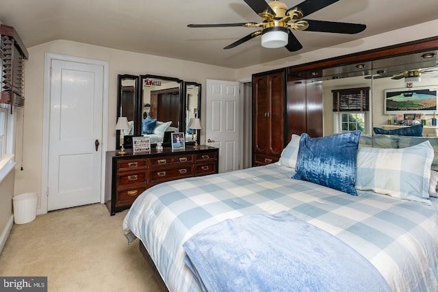 bedroom featuring light carpet and ceiling fan