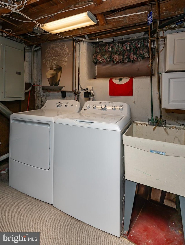 washroom with electric panel, sink, and washing machine and clothes dryer