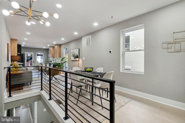 dining room featuring an inviting chandelier and light hardwood / wood-style floors