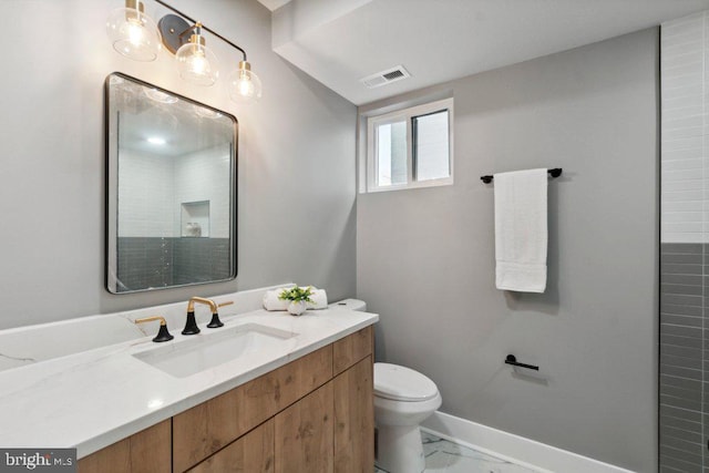 bathroom featuring toilet and vanity