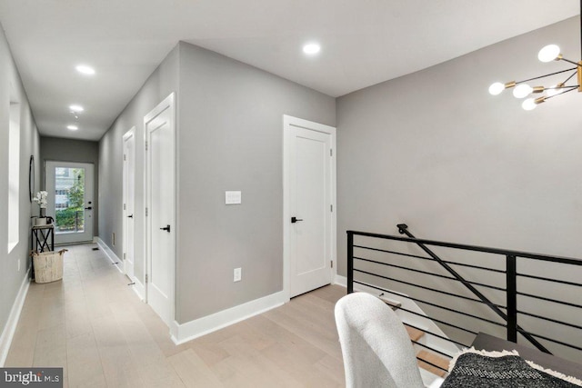 office area featuring a chandelier and light hardwood / wood-style flooring