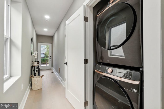 laundry room featuring stacked washer / drying machine