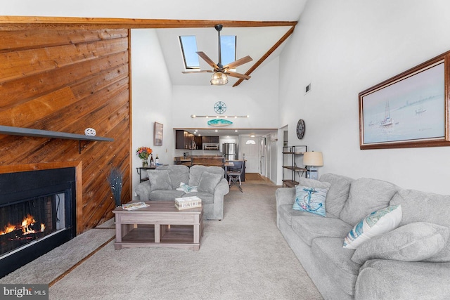 living room featuring ceiling fan, high vaulted ceiling, and carpet floors