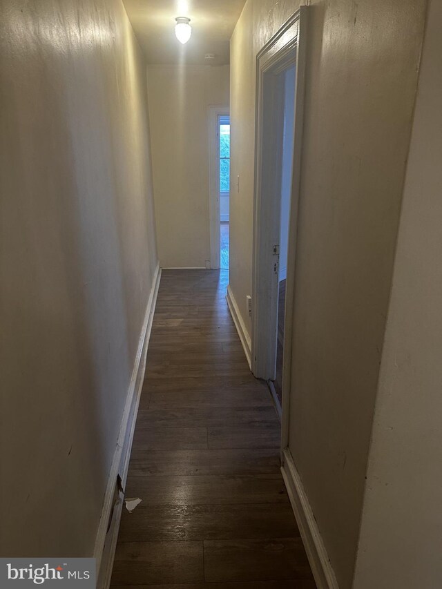 hallway with dark hardwood / wood-style flooring