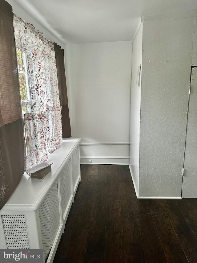 hallway with dark wood-type flooring