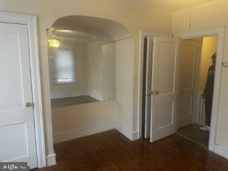 corridor featuring dark hardwood / wood-style flooring