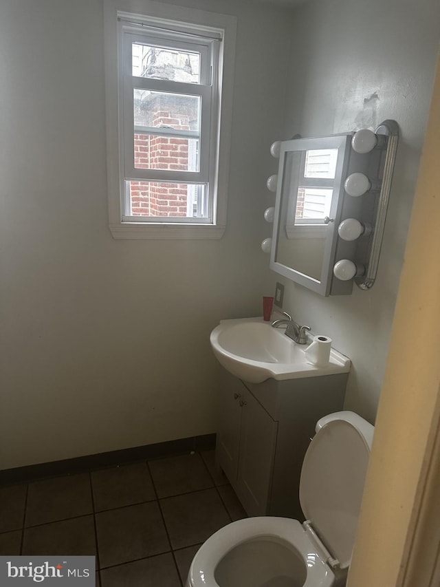 bathroom with vanity, toilet, and tile patterned floors