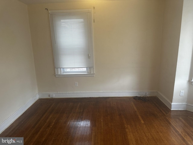 unfurnished room featuring dark hardwood / wood-style floors