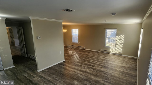 spare room featuring ornamental molding, a baseboard heating unit, and dark hardwood / wood-style floors