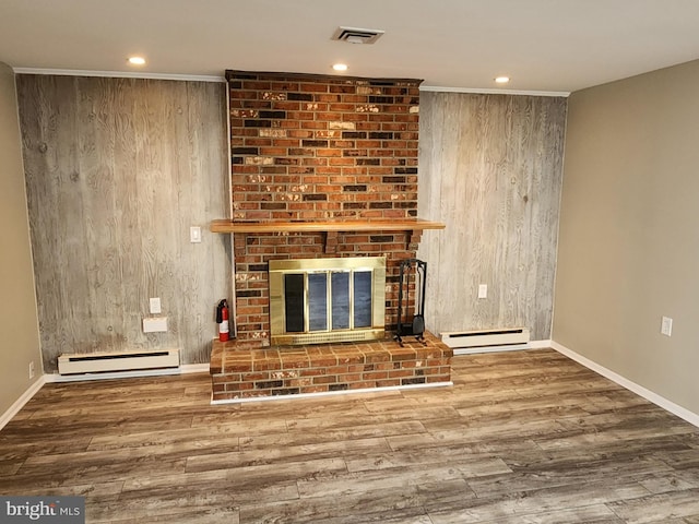 unfurnished living room with wooden walls, wood-type flooring, and a baseboard radiator