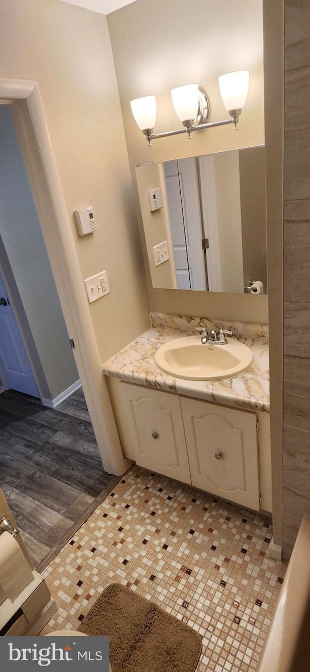 bathroom featuring vanity and hardwood / wood-style floors