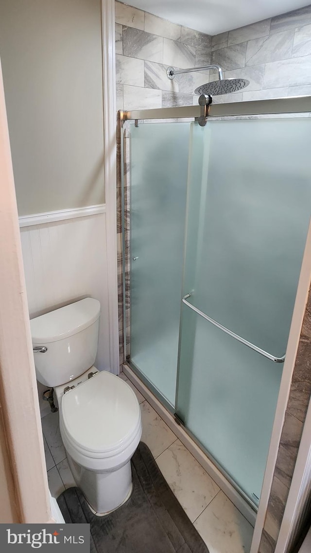 bathroom with toilet and walk in shower