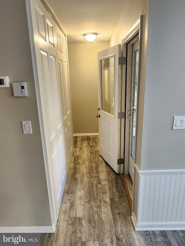 corridor with hardwood / wood-style floors