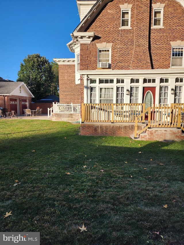 rear view of house with a yard, a patio, a deck, and cooling unit