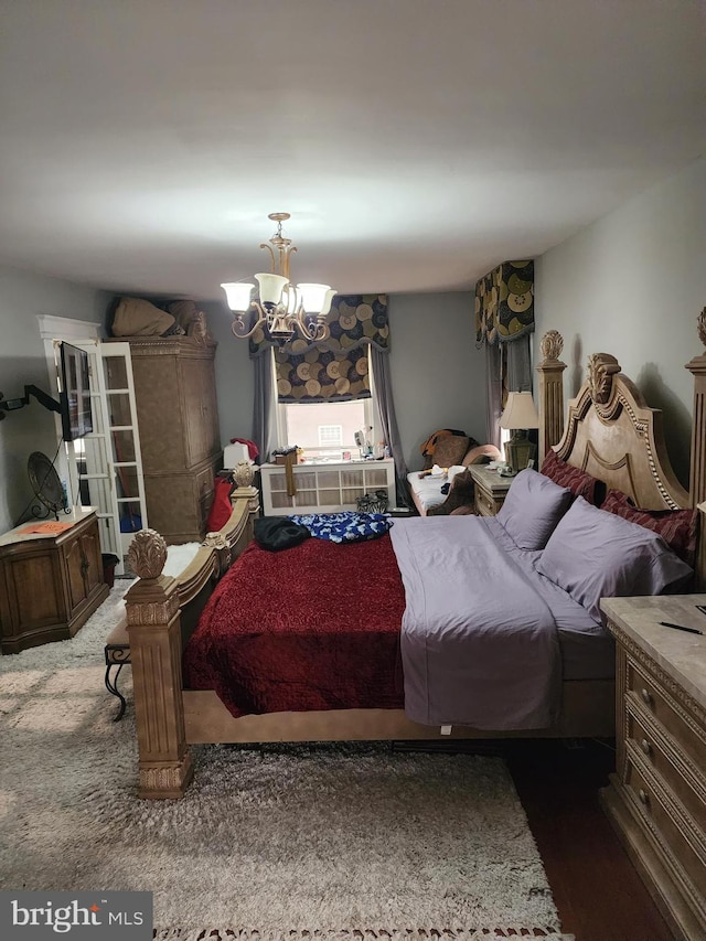 carpeted bedroom with a notable chandelier