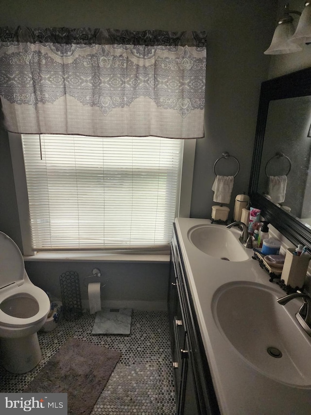 bathroom with vanity, toilet, and tile patterned flooring