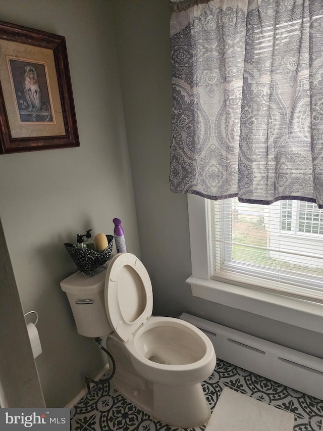 bathroom featuring toilet and tile patterned floors