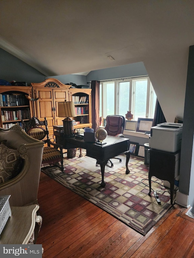 living room featuring dark hardwood / wood-style floors and vaulted ceiling