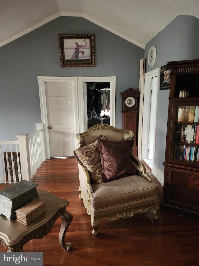 sitting room with vaulted ceiling and dark hardwood / wood-style flooring