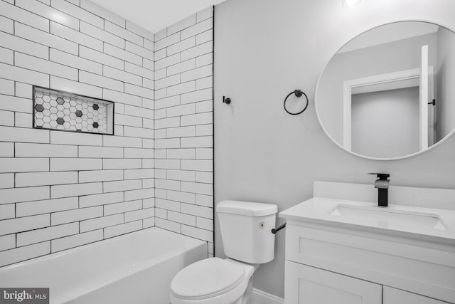 full bathroom with vanity, tiled shower / bath combo, and toilet