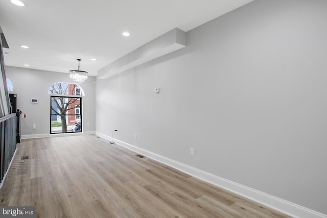 interior space featuring a chandelier and light wood-type flooring