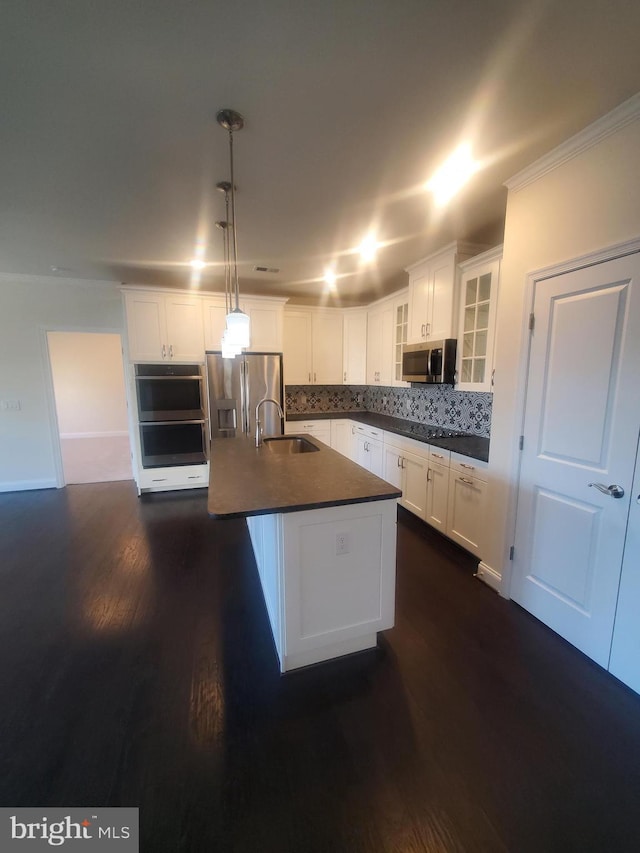 kitchen with decorative light fixtures, white cabinetry, dark wood-type flooring, and appliances with stainless steel finishes