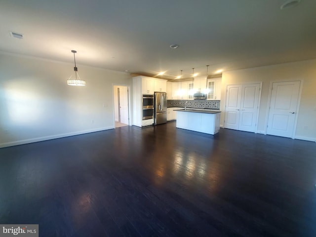 kitchen with white cabinets, pendant lighting, dark hardwood / wood-style flooring, and appliances with stainless steel finishes