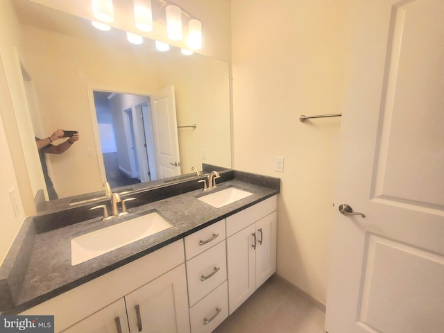 bathroom featuring tile patterned flooring and vanity