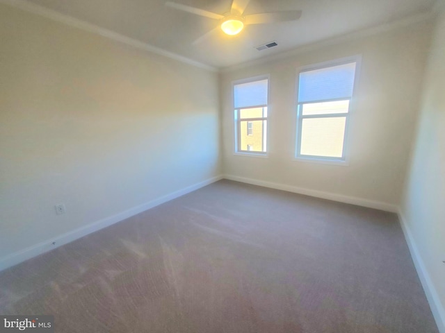 unfurnished room featuring ceiling fan, carpet floors, and ornamental molding