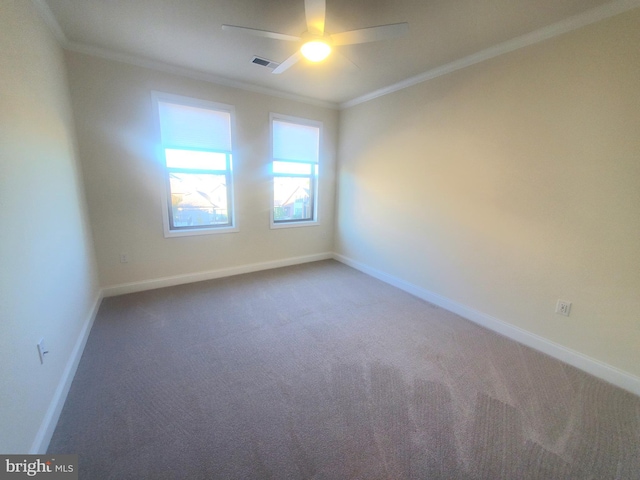 spare room featuring carpet, ceiling fan, and crown molding