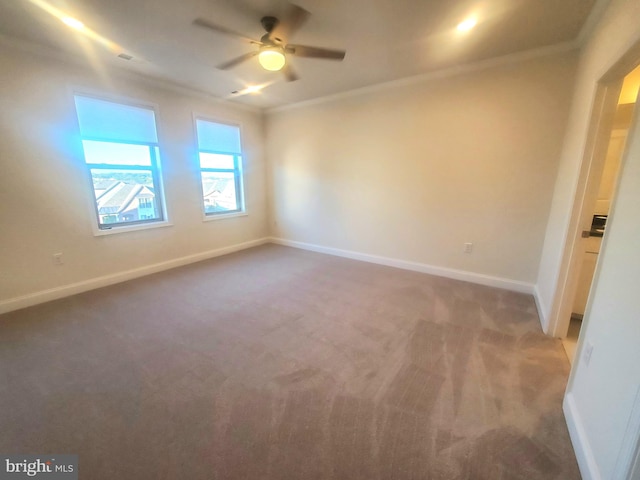 spare room with carpet, ceiling fan, and crown molding